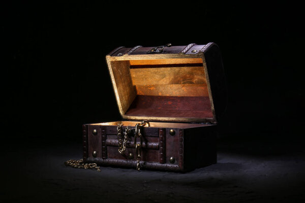 Decorative box with jewellery and glowing light on black background