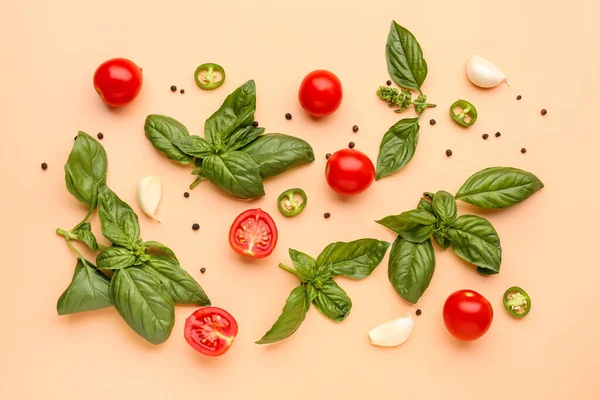 stock image Fresh basil, cherry tomatoes and peppercorn on orange background