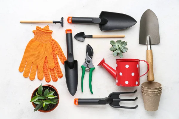 Composition with gardening tools on white background