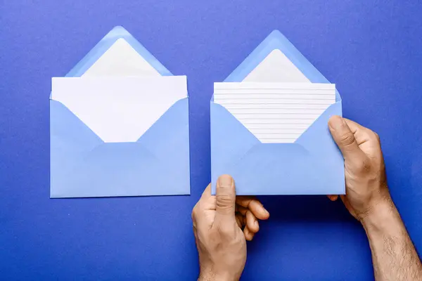 Mãos Masculinas Com Envelopes Cartões Branco Sobre Fundo Azul Close — Fotografia de Stock