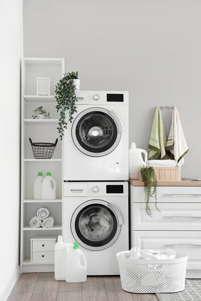 Laundry room with washing machines and white counters