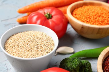 Mavi arka planda farklı taze sebzeler ve tahıllar.