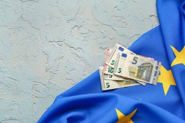 Banknotes and European Union flag on blue background