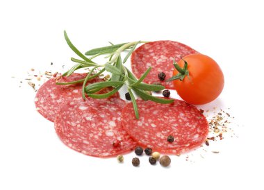 Slices of tasty salami with tomato and spices isolated on white background