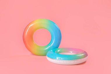 Inflatable rings on pink background