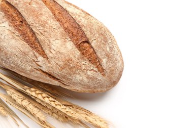Loaf of fresh rye bread and wheat ears isolated on white background