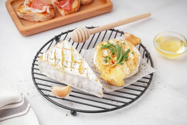 stock image Grid with tasty baked Camembert cheese on grey background