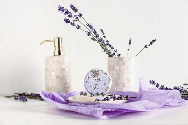 Composition with soap bars and lavender flowers on light background