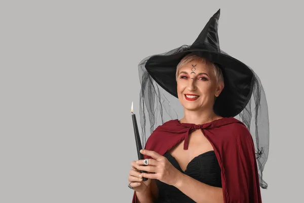 Mature Witch Burning Candle Grey Background — Stock Fotó