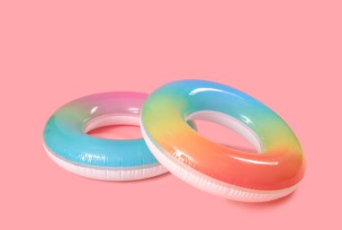 Inflatable rings on pink background