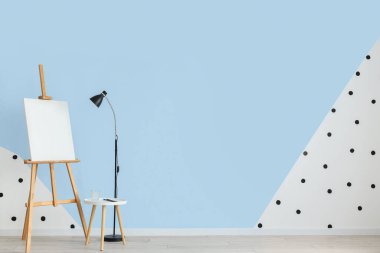 Mavi duvarın yanında lamba ve sehpa