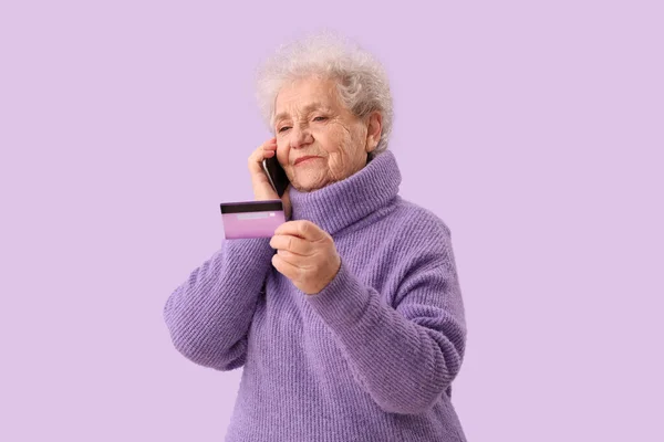 Senior Woman Credit Card Talking Mobile Phone Lilac Background — Stock Photo, Image