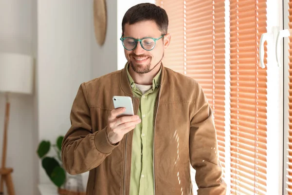 Handsome Man Stylish Eyeglasses Using Mobile Phone Home — Stock Photo, Image