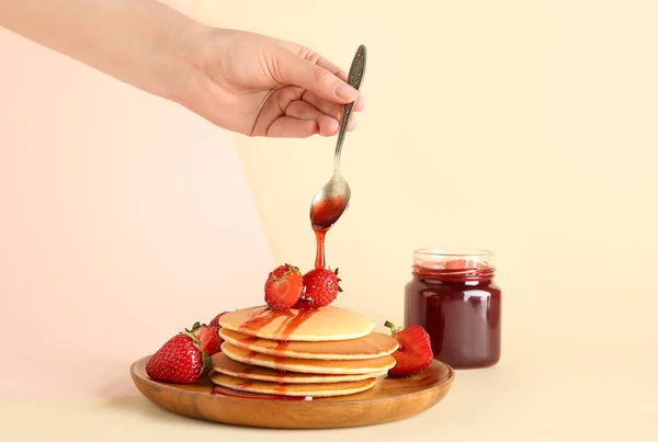 Woman Adding Sweet Strawberry Jam Pancakes Beige Background — Stock Photo, Image