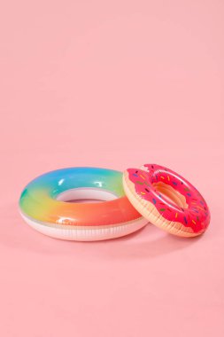 Inflatable rings on pink background