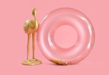 Swim ring with flamingo figure on pink background clipart