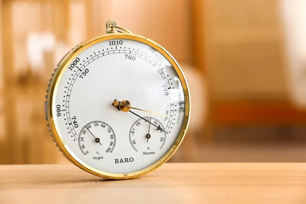 stock image Aneroid barometer on wooden table in room, closeup