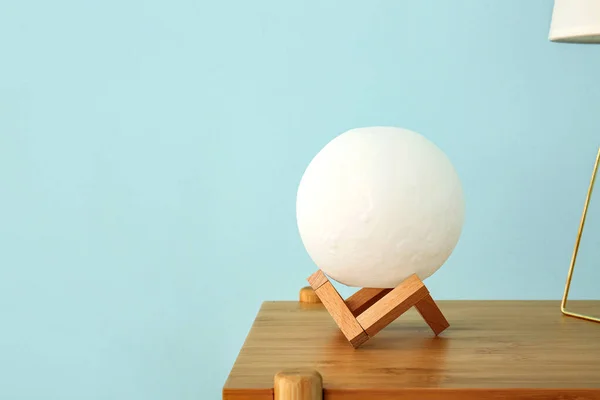 Moon Shaped Lamp Wooden Table Blue Wall — Stock Photo, Image