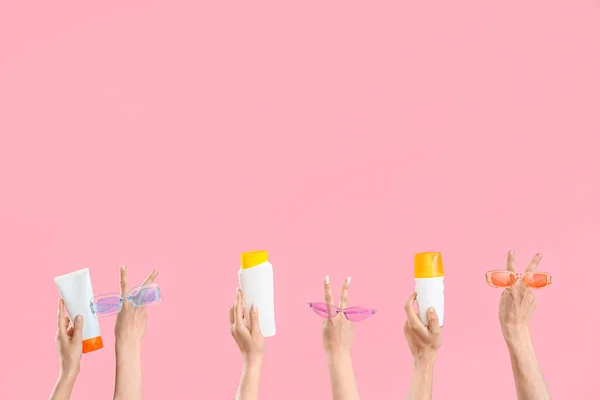 Female Hands Bottles Sunscreen Cream Sunglasses Pink Background — Stock Photo, Image