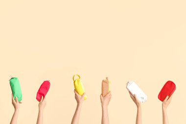 Hands with school supplies on beige background