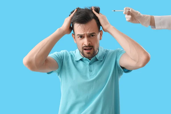 Worried Young Man Doctor Injection Hair Growth Blue Background — Stock Photo, Image