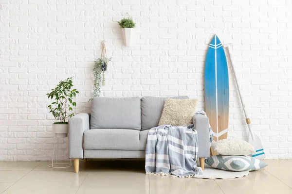 设有冲浪板 船桨及沙发的客厅室内 — 图库照片