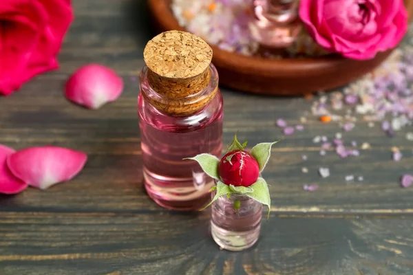 Bottles Cosmetic Oil Rose Extract Flowers Wooden Table — Stock Photo, Image