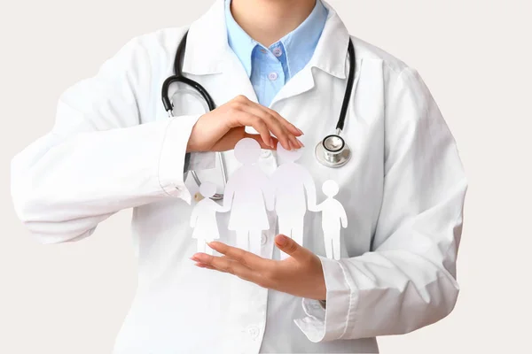 Ärztin Mit Familienfiguren Und Stethoskop Auf Weißem Hintergrund Gesundheitskonzept — Stockfoto