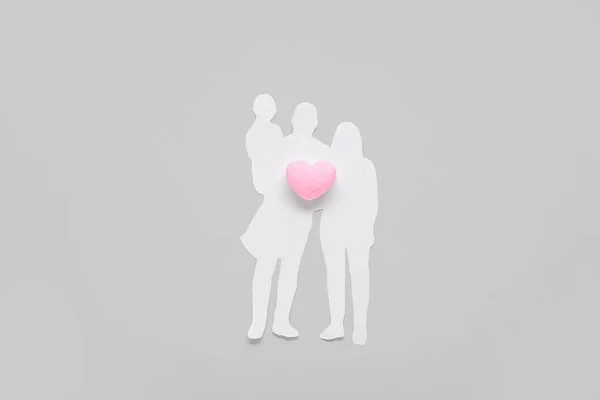 Figures of family with heart on grey background. Family love concept