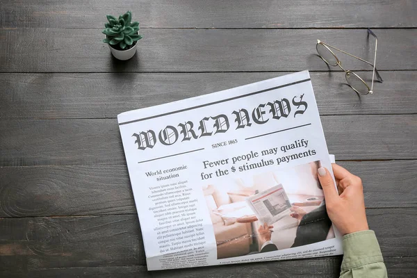Woman Reading Newspaper Black Wooden Background — Stock Photo, Image
