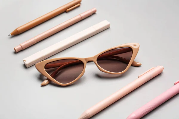 Stylish Sunglasses Stationery Supplies Grey Background — Stock Photo, Image