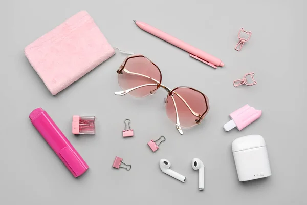 Stylish Sunglasses Stationery Supplies Earphones Grey Background — Stock Photo, Image
