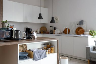 Ahşap masadaki modern aletlerle aydınlık mutfağın içinde.