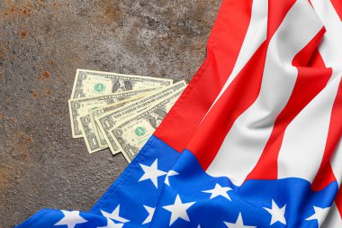 ABD bayrağı ve kahverengi arka planda dolar banknotları