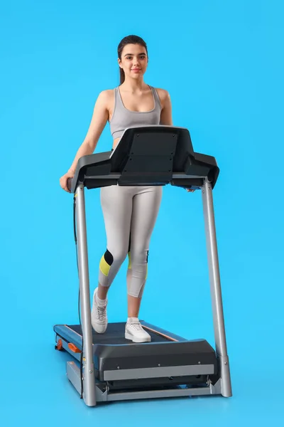 Sporty Young Woman Training Treadmill Blue Background — Stock Photo, Image