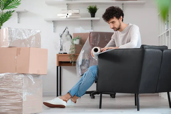 Young Man Wrapping Sofa Stretch Film Office — Stock Photo, Image