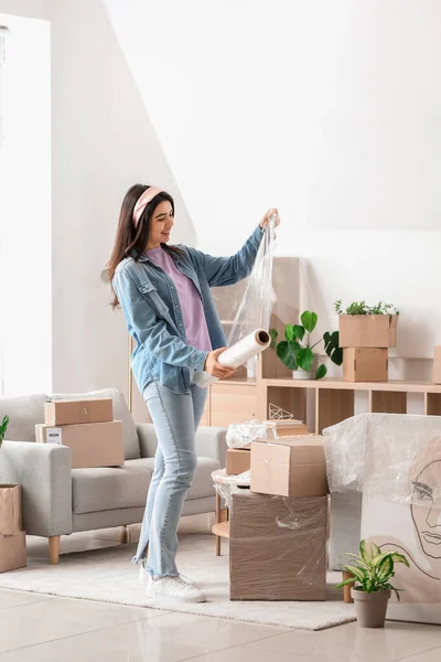 Young Woman Roll Stretch Wrap Home Moving Day — Stock Photo, Image