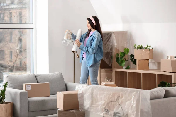 Young Woman Wrapping Lamp Stretch Film Home Moving Day — Stock Photo, Image