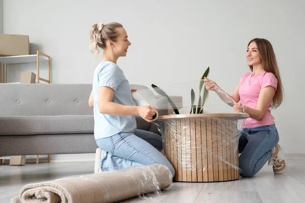 Young Women Wrapping Coffee Table Stretch Film Home — Stock Photo, Image