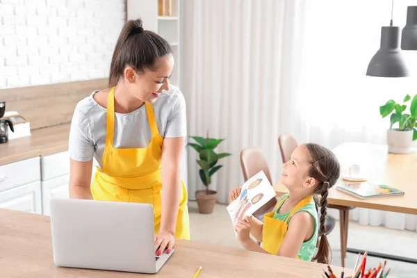 Little Girl Showing Drawing Her Working Mother Kitchen — Stock Photo, Image