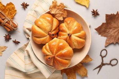 Gri arka planda lezzetli balkabağı şekilli çörekler