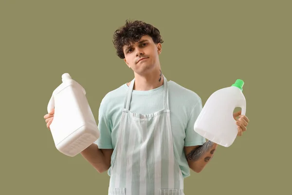 Young Man Bottles Detergent Green Background — Stock Photo, Image