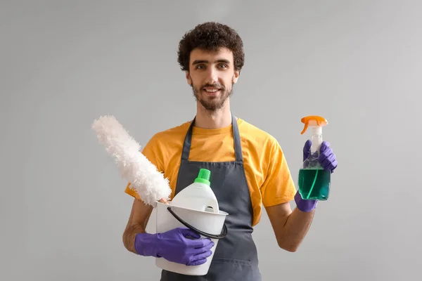 Young Man Bucket Cleaning Supplies Grey Background — Stock Photo, Image
