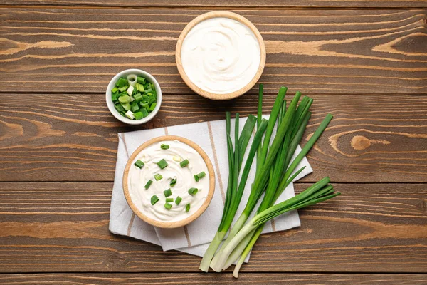 Bowls Tasty Sour Cream Green Onion Wooden Background — Stock Photo, Image