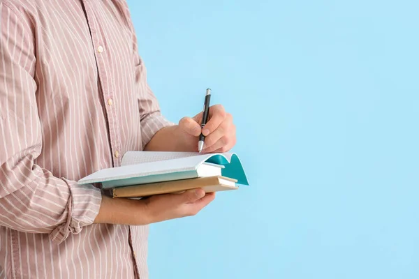 Male Student Writing Notebook Blue Background — Stock Photo, Image