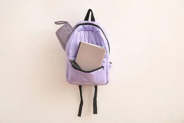 stock image Lilac school backpack with stationery on light background