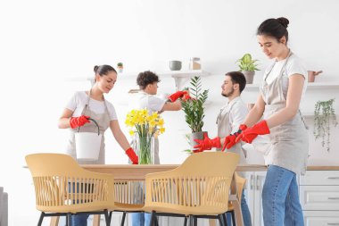 Young janitors cleaning in kitchen