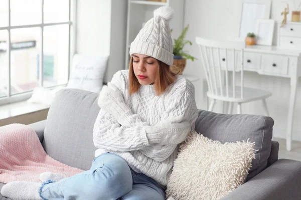 Frozen Young Woman Winter Clothes Sitting Sofa Home — Fotografia de Stock