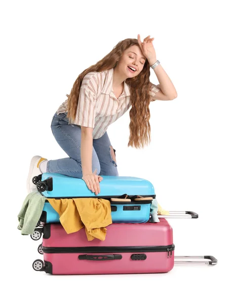 Tired Young Woman Trying Close Suitcase Lot Things White Background — Stock Photo, Image