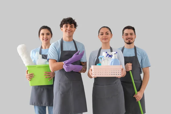 Young Janitors Cleaning Supplies Grey Background — Stock Photo, Image